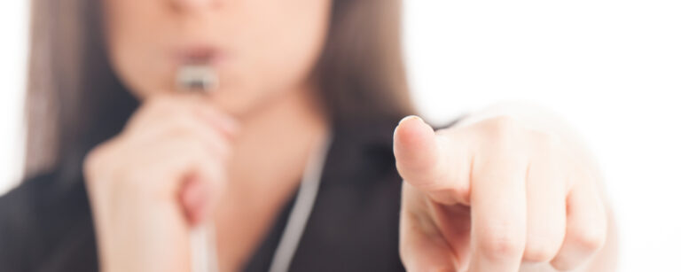 An individual's hand holding a red whistle against a white background, with the words 'Whistleblower Protection' written in bold black letters on the top and bottom of the image.