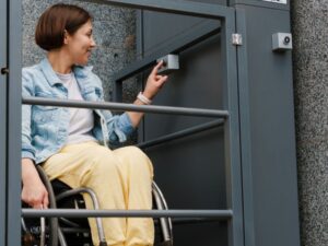 disabled woman using special elevator at work